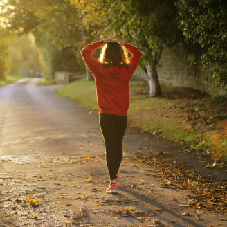 Mujer corriendo en un parque como parte de una rutina saludable